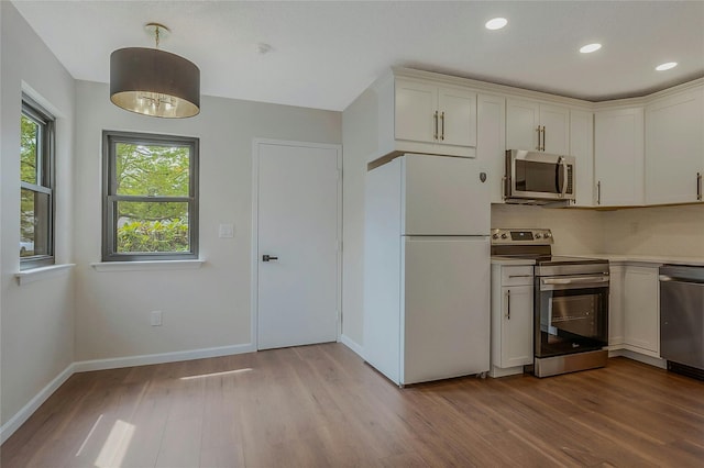 122 Knolls Dr Unit 122, Stony Brook, NY 11790 - kitchen featuring light countertops, appliances with stainless steel finishes, white cabinets, and light wood-style flooring