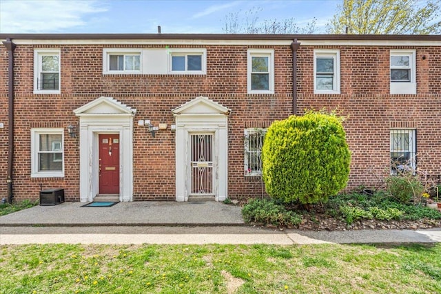 view of property featuring central AC and brick siding