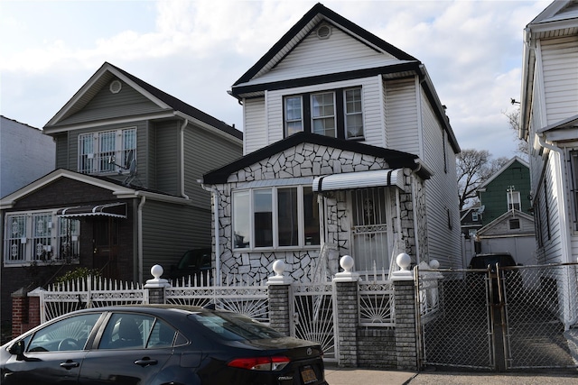 139-15 89th Ave, Briarwood, NY 11435 - view of front of property with stone siding, a gate, and a fenced front yard