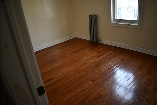 139-15 89th Ave, Briarwood, NY 11435 - spare room featuring radiator heating unit, baseboards, and dark wood-style floors