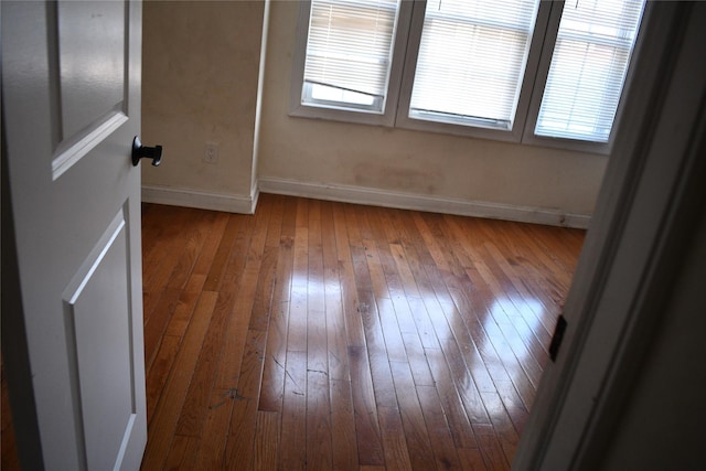 139-15 89th Ave, Briarwood, NY 11435 - unfurnished bedroom with wood-type flooring and baseboards