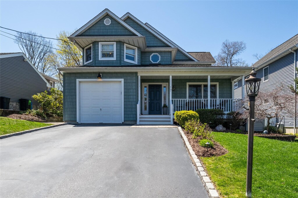 17 Juniper Pl, Huntington, NY 11743 - view of front of property featuring a porch, an attached garage, driveway, and a front yard