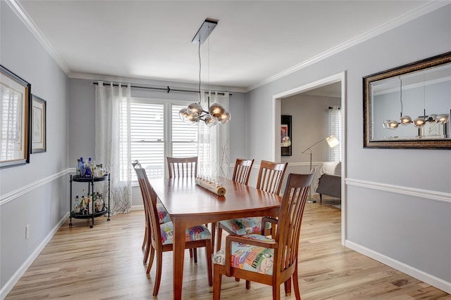 dining room with light wood-style flooring, baseboards, a chandelier, and ornamental molding