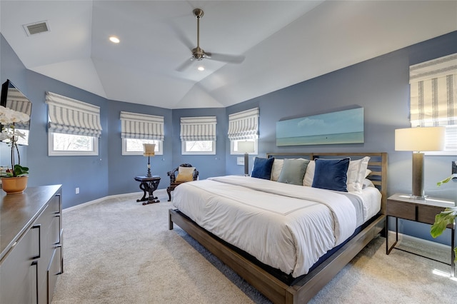 bedroom featuring light colored carpet, lofted ceiling, multiple windows, and visible vents
