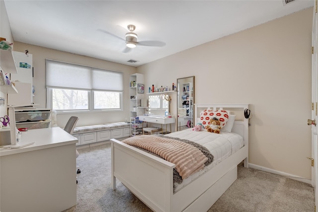 bedroom with light colored carpet, ceiling fan, baseboards, and visible vents