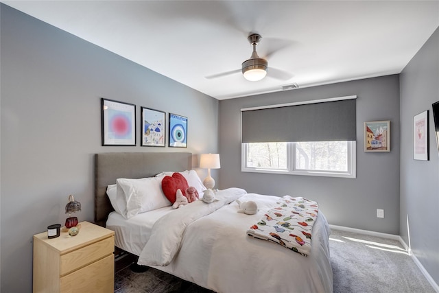bedroom featuring visible vents, dark colored carpet, baseboards, and ceiling fan