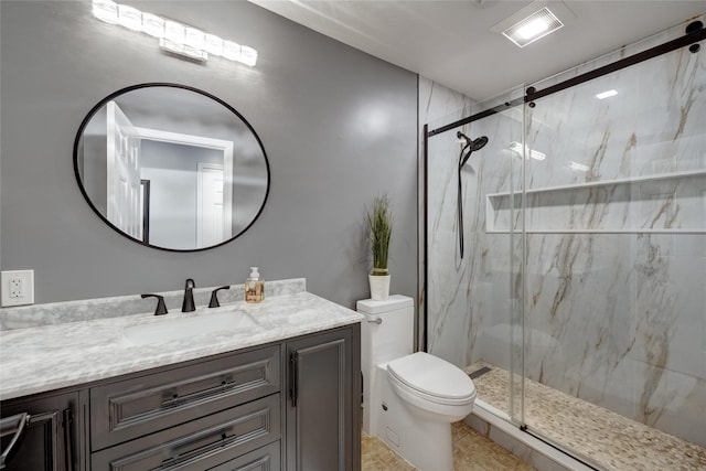 bathroom with visible vents, vanity, a marble finish shower, and toilet