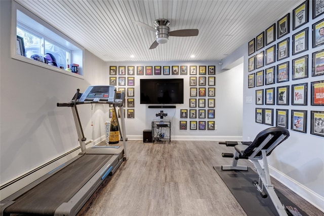 workout area featuring baseboards, a ceiling fan, wood finished floors, and wooden ceiling