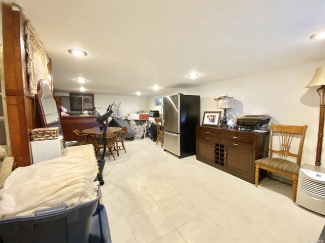 4947 166th St, Fresh Meadows, NY 11365 - bedroom with recessed lighting, freestanding refrigerator, and light tile patterned floors