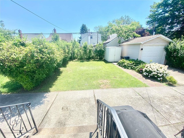 4947 166th St, Fresh Meadows, NY 11365 - view of yard with an outdoor structure, a storage unit, and a garage