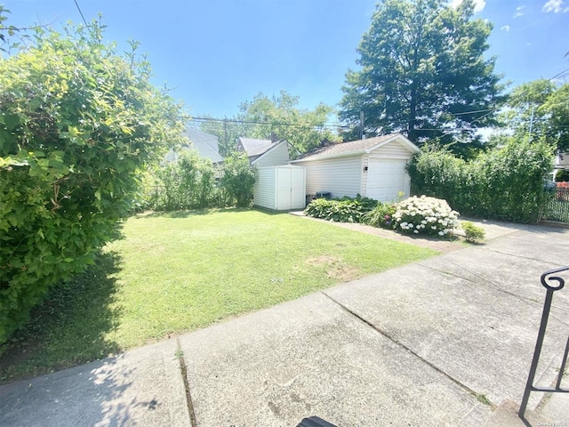 4947 166th St, Fresh Meadows, NY 11365 - view of yard with fence, an outdoor structure, a storage unit, and a garage