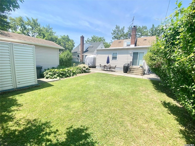 4947 166th St, Fresh Meadows, NY 11365 - back of property with entry steps, a yard, a shed, an outbuilding, and a patio