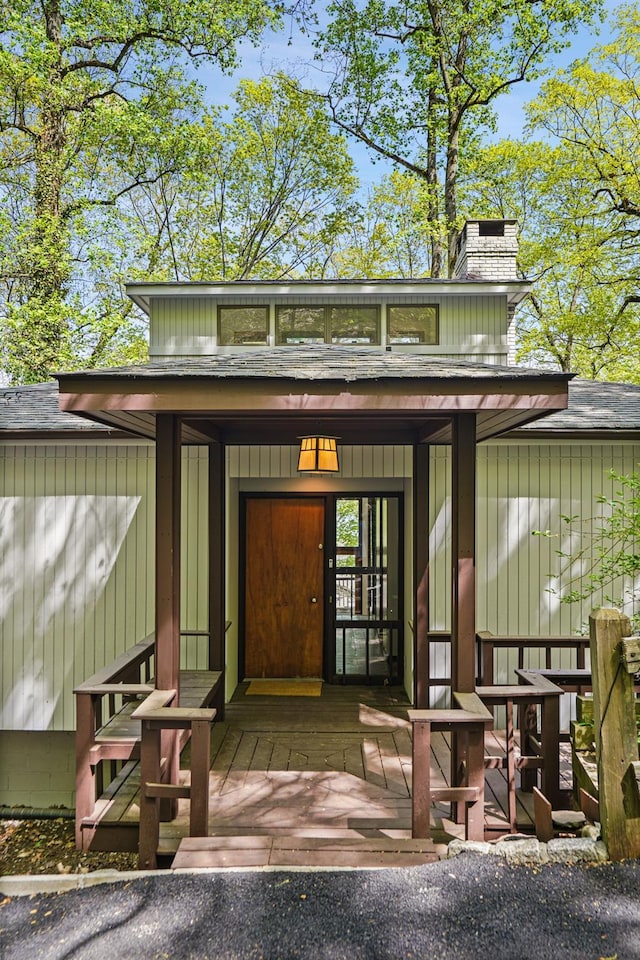 entrance to property featuring a chimney