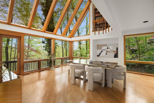 sunroom featuring wood finished floors and visible vents