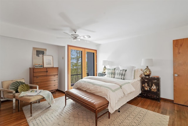 bedroom featuring ceiling fan, access to exterior, and wood finished floors