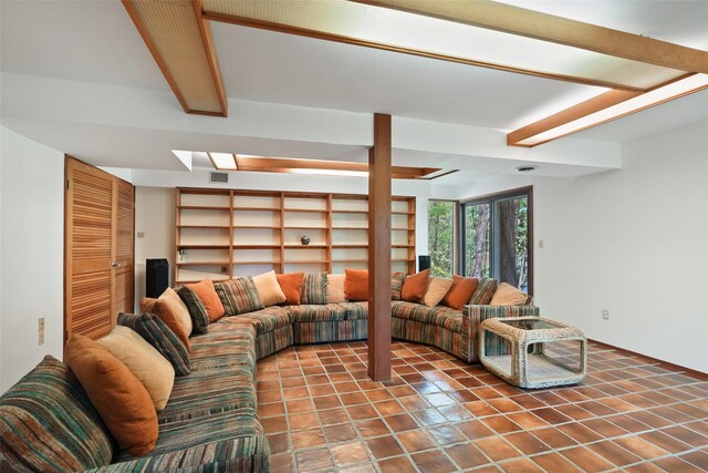 tiled living area featuring a skylight and visible vents