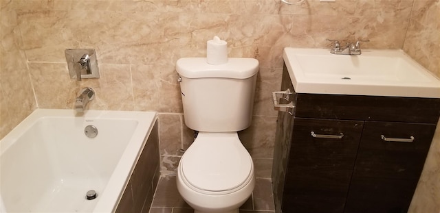 bathroom featuring vanity, a bath, tile walls, and toilet