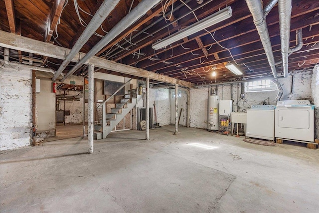 below grade area featuring independent washer and dryer, a sink, stairway, and water heater