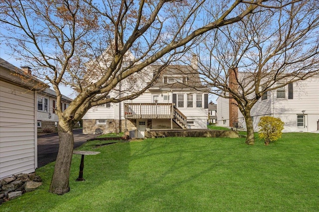 back of house with a yard, stairway, and a wooden deck
