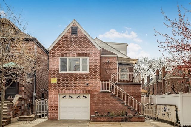 view of front of home featuring an attached garage, concrete driveway, fence, stairs, and brick siding