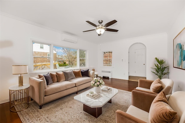 living area featuring ceiling fan, radiator, wood finished floors, and a wall unit AC