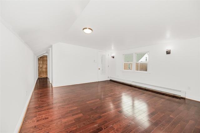 unfurnished living room featuring baseboard heating, wood finished floors, baseboards, and lofted ceiling
