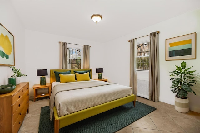 bedroom featuring light tile patterned floors and multiple windows