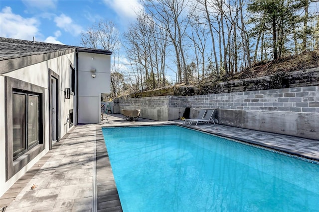 view of pool with a fenced in pool, a patio, and fence