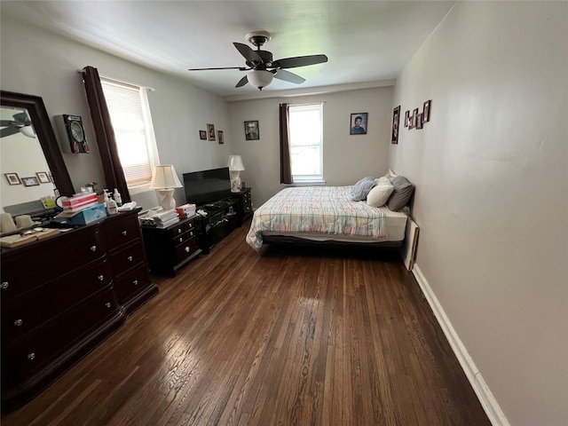 bedroom featuring baseboards, dark wood-style floors, and ceiling fan