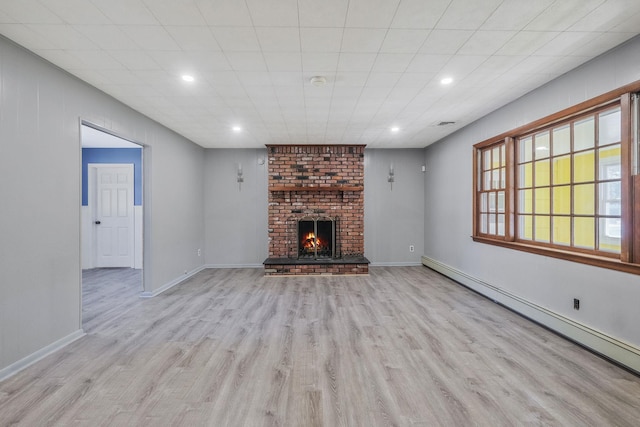 unfurnished living room featuring a baseboard heating unit, baseboards, recessed lighting, wood finished floors, and a fireplace