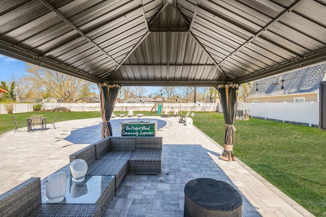 view of patio with a gazebo, outdoor lounge area, a fenced backyard, and a playground