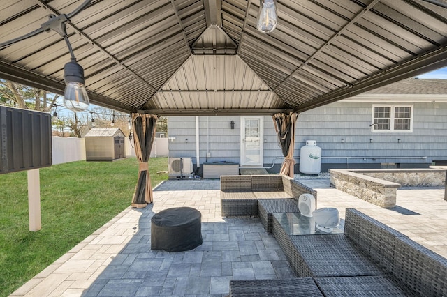 view of patio / terrace with a gazebo, outdoor lounge area, an outbuilding, and a storage shed