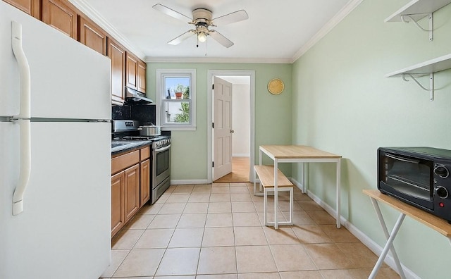 107-50 90th St, Ozone Park, NY 11417 - kitchen featuring baseboards, ornamental molding, freestanding refrigerator, under cabinet range hood, and stainless steel gas stove