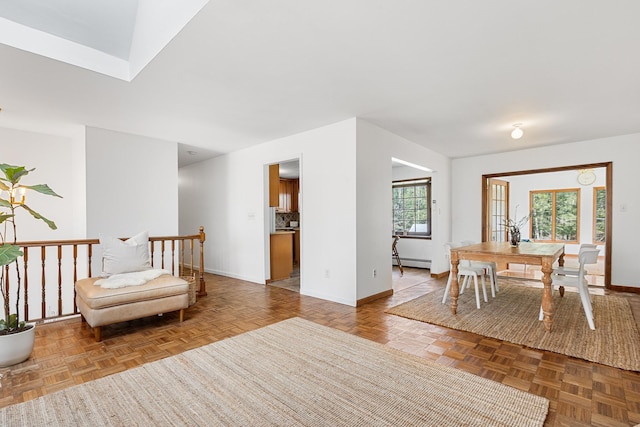 living area with a baseboard radiator and baseboards