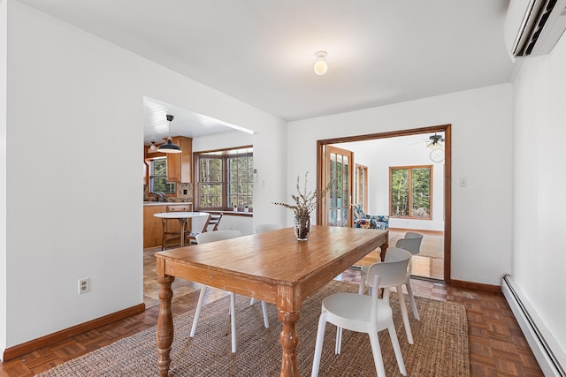 dining space featuring a baseboard heating unit, a wall mounted AC, baseboards, and ceiling fan