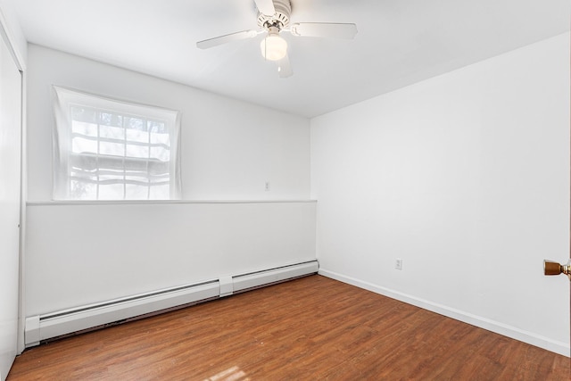 unfurnished room featuring baseboards, baseboard heating, wood finished floors, and ceiling fan