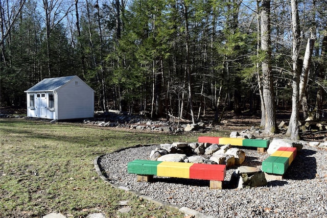 view of yard featuring a storage unit and an outbuilding