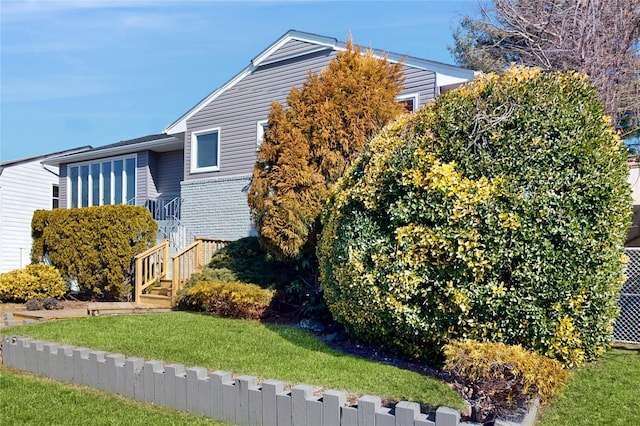 view of home's exterior featuring a yard