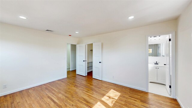 unfurnished bedroom featuring recessed lighting, light wood finished floors, and visible vents
