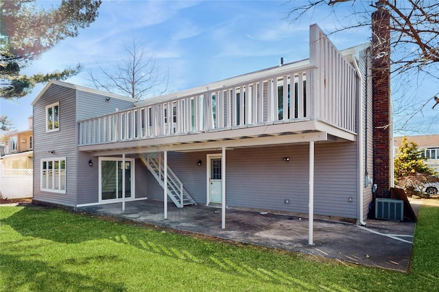 back of house featuring central AC, a deck, stairway, a patio area, and a lawn