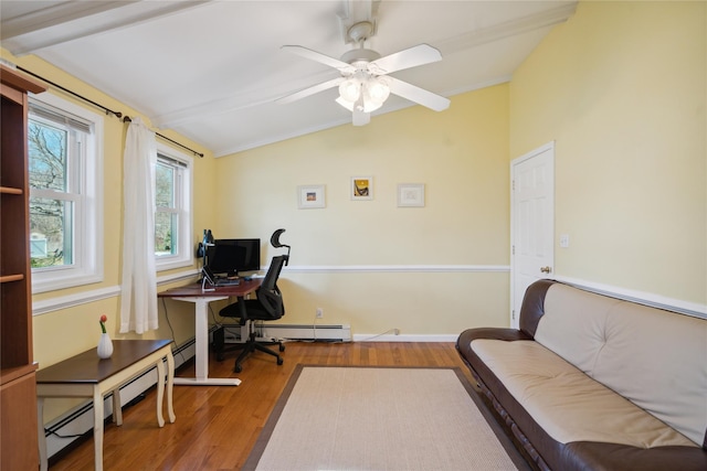 office area with a ceiling fan, vaulted ceiling, wood finished floors, and a baseboard heating unit