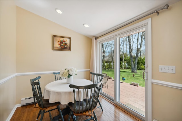 dining room with recessed lighting, baseboards, vaulted ceiling, and hardwood / wood-style floors