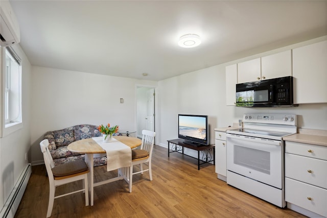 kitchen with a wall unit AC, black microwave, baseboard heating, light wood finished floors, and electric stove