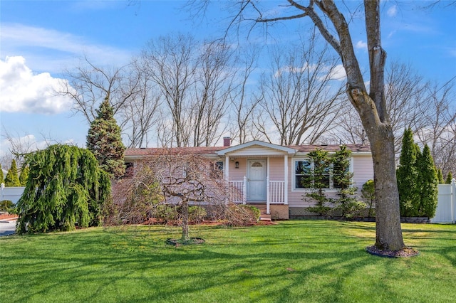 ranch-style home with a chimney, fence, and a front yard