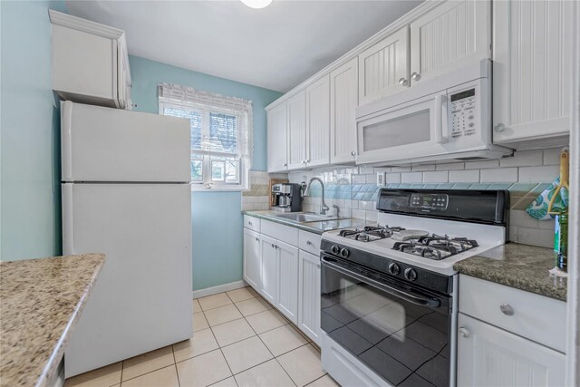 kitchen featuring white cabinetry, decorative backsplash, a sink, and white appliances