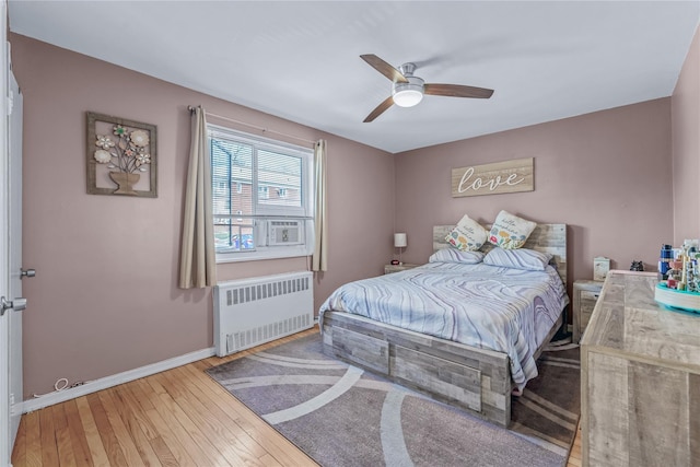 bedroom featuring wood-type flooring, baseboards, radiator, and ceiling fan