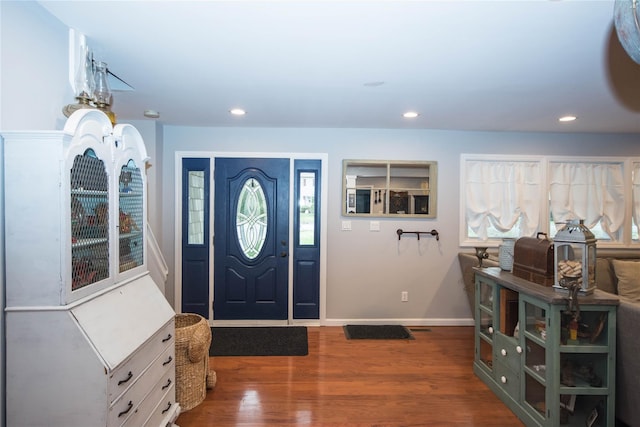 entryway with recessed lighting, wood finished floors, and baseboards