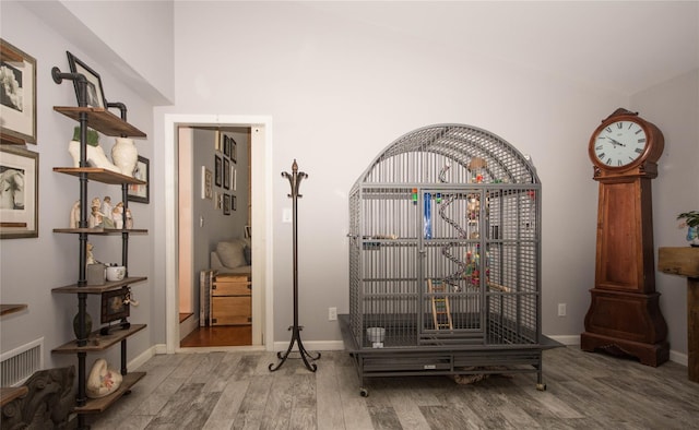 room details featuring a gate, baseboards, wood finished floors, and visible vents