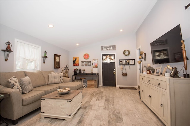 living area featuring vaulted ceiling, light wood finished floors, and recessed lighting