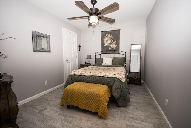 bedroom featuring wood finished floors, a ceiling fan, and baseboards